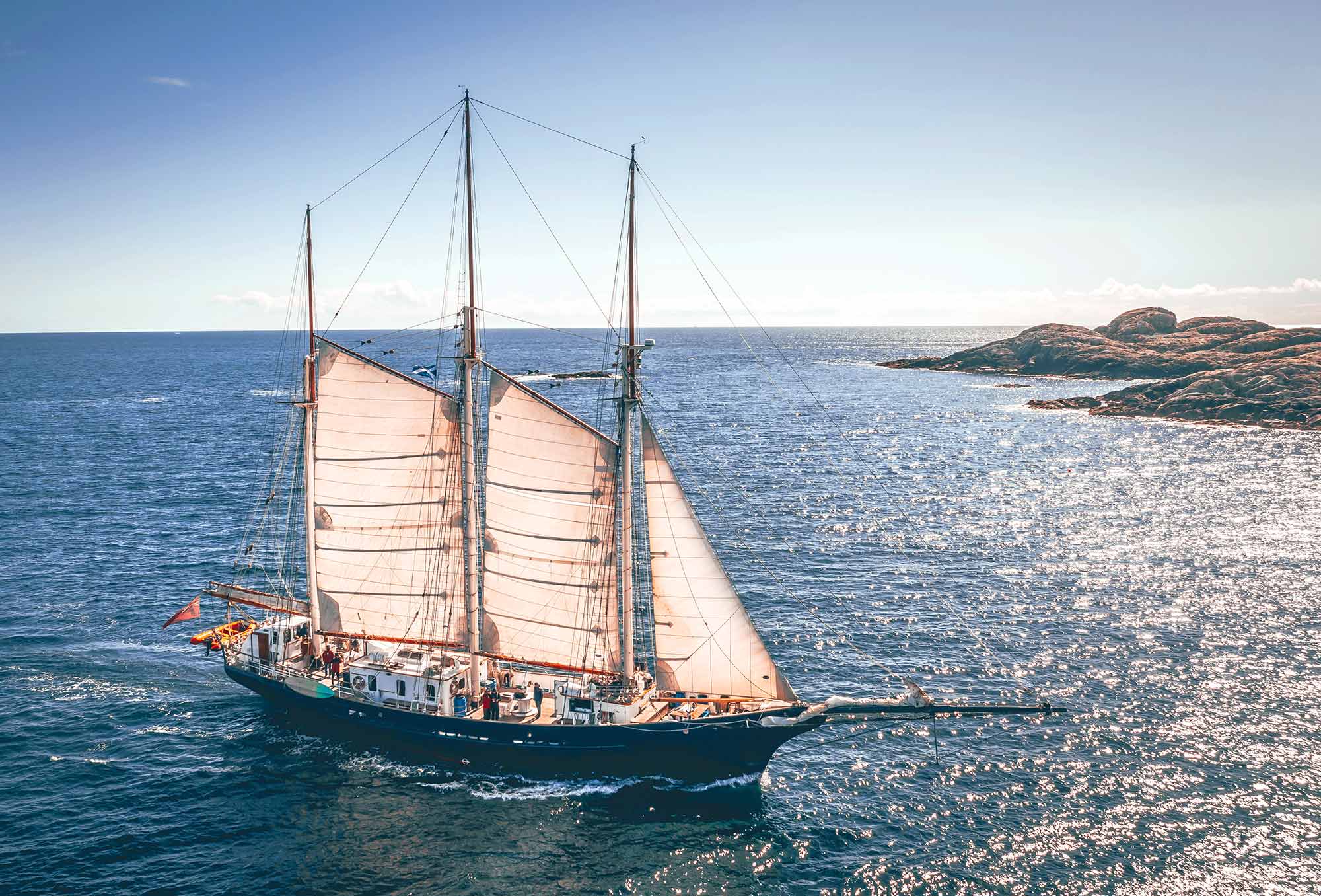 A two-masted schooner under sail